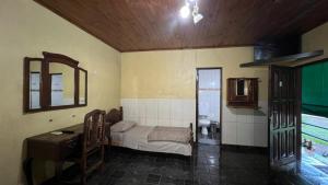 a bedroom with a bed and a sink and a mirror at Punto Clave in Posadas