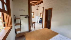 a bedroom with a bed and a ladder in a room at Milho Ventura II, Vila Pôr do Sol in Sêrro