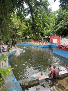 a group of people playing in a swimming pool at Casa Ampla Vila Muriqui in Vila Muriqui