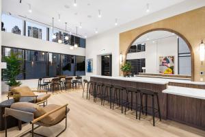 a bar in a restaurant with chairs and tables at Prime Downtown Miami Location with Rooftop Pool in Miami