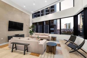 a living room with a couch and a tv at Prime Downtown Miami Location with Rooftop Pool in Miami +21 photos