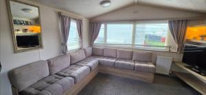 a living room with a couch and a large window at Vanhalla in Heysham