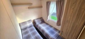 a small room with a couch and a window at Vanhalla in Heysham
