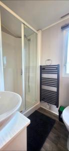 a bathroom with a shower and a tub and a sink at Vanhalla in Heysham +44 photos
