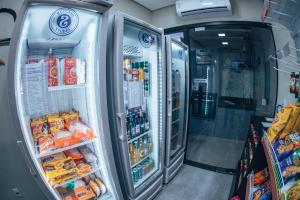 a refrigerator filled with lots of food and drinks at Zuccaro Studio in Bauru