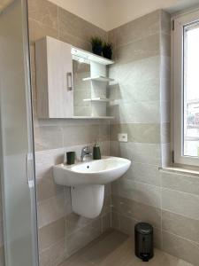 a bathroom with a sink and a mirror at Antico Borgo San Zeno in Bardolino +31 photos