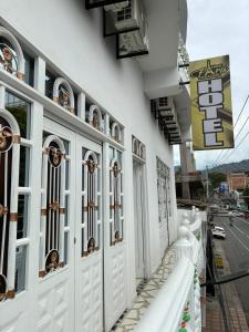 a building with white doors and windows on a street at Hotel Paris Mirador in Garzón