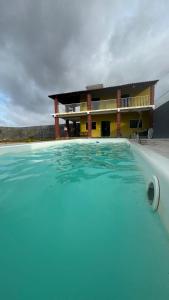 a large swimming pool in front of a building at Dunas Exclusive in Santo Amaro