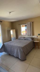 a bedroom with a large bed with a window at Dunas Exclusive in Santo Amaro +24 photos
