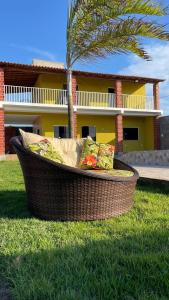 a couch sitting in the grass in front of a house at Dunas Exclusive in Santo Amaro