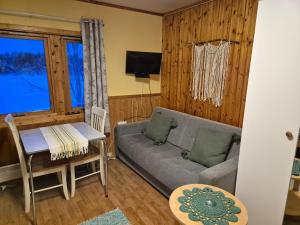 a living room with a couch and a table at Alta River Camping in Alta