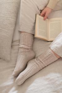 a person laying on a bed with a book at De Rheezer Kamer in Hardenberg