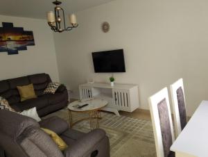 a living room with a couch and a tv at Unity Homes Eldoret in Eldoret