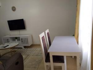 a living room with a white table and chairs at Unity Homes Eldoret in Eldoret