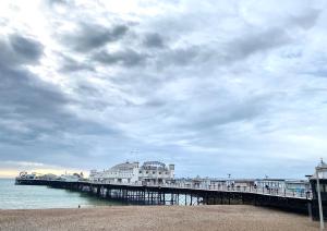 a pier with a building on the water at Guest And The City in Brighton & Hove