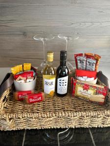 a basket with alcohol and snacks on a table at The paddocks in Wisbech