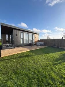 a house with a large backyard with a lawn at The paddocks in Wisbech