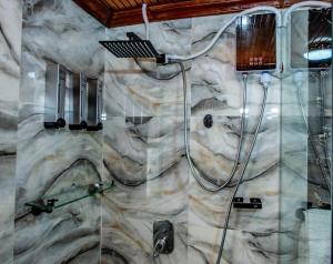 a bathroom with a shower and a sink at Cozy Stead Hotel - Haven House, Gigiri in Nairobi +110 photos