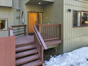 a porch of a house with snow on the ground at Yosemite Spirit in Yosemite West