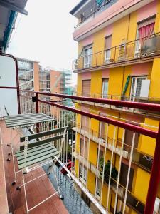 a balcony with two benches and a building at Dolce Hogar Residence in Chiavari