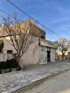 a brick building on the side of a street at Lozi House Cozy Stay in Al Azraq ash Shamālī