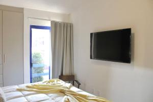a bedroom with a flat screen tv on the wall at Charming Suite Pool AC Location 10C in San Pablo
