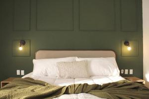 a bedroom with a bed with two lights on the wall at Charming Suite Pool AC Location 10C in San Pablo +19 photos