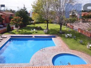 a large swimming pool in a yard with a grassy field at Charming Suite Pool AC Location 10C in San Pablo