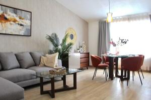 a living room with a couch and a table at Charming Suite Pool AC Location 10C in San Pablo