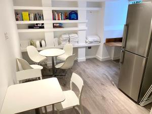 a kitchen with a table and chairs and a refrigerator at Guest And The City in Brighton & Hove
