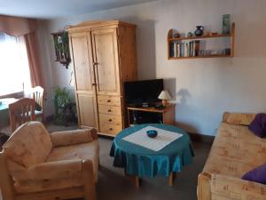 a living room with a couch and a coffee table at Ferienhaus Inge in Ilmenau