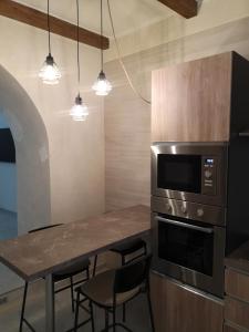 a kitchen with a table with chairs and a microwave at Bed and relax in Serre +12 photos