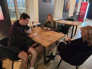 a group of people sitting at a table in a restaurant at Hedgehogs backpackers hostel in Riga