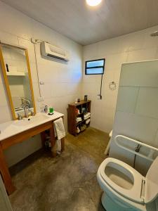 a bathroom with a toilet and a sink and a mirror at Los Eucaliptos in Duggan