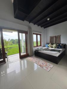 a bedroom with a large bed and a balcony at Rumi Bumi Lovina - A Home For Unhurried Days in Lovina +45 photos