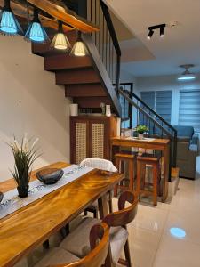 a dining room with a wooden table and a staircase at Haven on the Hill near Twin Lakes in Calo