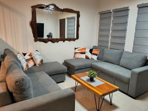 a living room with couches and a table and a mirror at Haven on the Hill near Twin Lakes in Calo +75 photos