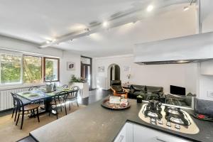 a kitchen and living room with a table and chairs at Menaggio 57 in Menaggio