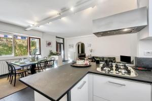 a kitchen with a counter top and a dining room at Menaggio 57 in Menaggio
