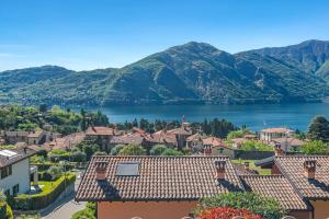 a town with a lake and mountains in the background at Villa Tremezzo in Tremezzo