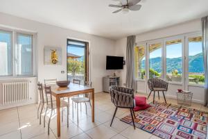a living room with a dining room table and chairs at Villa Tremezzo in Tremezzo +31 photos