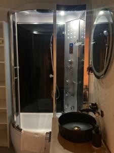 a bathroom with a shower with a black tub in it at Willa Zakopane Center in Zakopane +29 photos