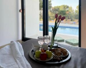 a table with a plate of food and wine glasses at White Villa, Brac in Splitska