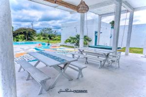 a patio with a table and a pool at Epic Wild Wilpattu in Nochchiyagama +69 photos