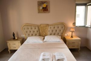 a bedroom with a large bed with two night stands at Pargamaisonnette in Parga +55 photos