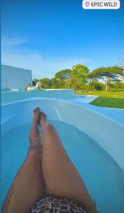 a person laying on the edge of a swimming pool at Epic Wild Wilpattu in Nochchiyagama