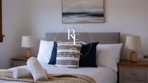 a bed with a r sign on top of it at The Den at Braehead in Cruden Bay +3 photos