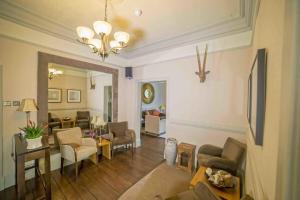 a living room with a couch and chairs and a table at The Abbotsford in Callander