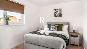 a bedroom with a bed and a window at The Den at Catto in Peterhead
