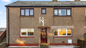 a brick house with the word repair written on it at The Den at Catto in Peterhead